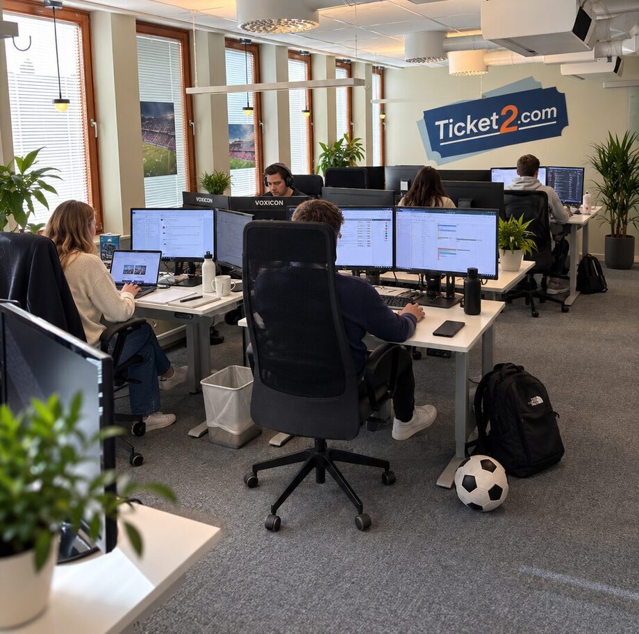 The Ticket2 office: staff at their screens under the Ticket2.com sign